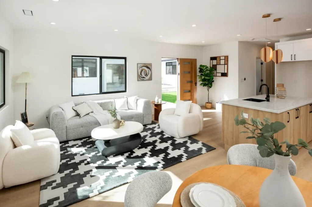 Open Los Gatos living room with light seating, a graphic rug, and warm wood accents